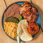 Chipotle BBQ chicken plate with rice, refried beans, grilled tomato and a flour tortilla